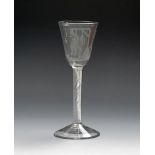 A good Admiral Byng wine glass, c.1763, the round funnel bowl engraved with the admiral hanging from