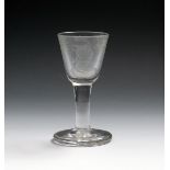 A Williamite firing glass, c.1760, engraved with a portrait of the King within the inscription '