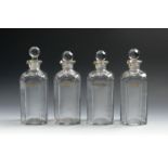 A set of four liqueur decanters and stoppers, c.1800, of chamfered square form, each titled in