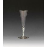 A rare colour-twist ale glass, c.1770, the tall flute bowl moulded with wide ribs, rising from a