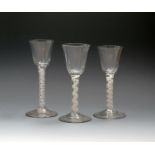 Three wine glasses, c.1760, all with rounded funnel bowls, one moulded with vertical flutes, all