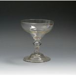 A rare champagne or mead glass, c.1750, the generous ogee bowl raised from, a short baluster stem