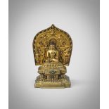 A RARE TIBETAN GILT BRONZE FIGURE OF BUDDHA SAKYAMUNI 14TH/15TH CENTURY Seated on a double lotus