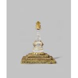 A NEPALESE ROCK CRYSTAL AND GILT COPPER MODEL OF A STUPA 18TH/19TH CENTURY The crystal pillar