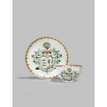 A CHINESE ARMORIAL TEA BOWL AND SAUCER DATED 1748 Decorated with the initials HH and a merchant's