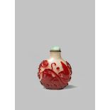 A CHINESE RED-OVERLAY GLASS 'CARP' SNUFF BOTTLE 19TH CENTURY With a flattened circular body carved