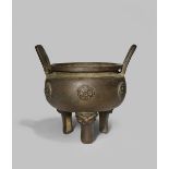 A CHINESE BRONZE TRIPOD INCENSE BURNER QING DYNASTY With a compressed circular body cast with six