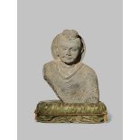 A GANDHARAN GREY SCHIST BUST OF BUDDHA SAKYAMUNI 3RD/4TH CENTURY AD His shoulders covered with a