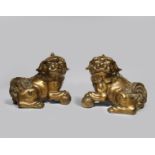 A PAIR OF CHINESE GILT BRONZE BUDDHIST LION DOGS MING DYNASTY Seated on their haunches with their