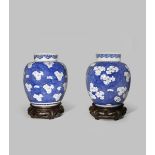 A NEAR PAIR OF CHINESE BLUE AND WHITE 'PRUNUS' JARS AND COVERS KANGXI 1662-1722 Each with an ovoid