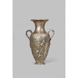 A CHINESE SILVER TWO-HANDLED VASE 19TH CENTURY The ovoid body decorated with four repoussé and