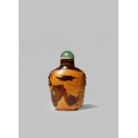 A CHINESE AMBER SNUFF BOTTLE 19TH CENTURY With a flattened circular body with lion mask handles to