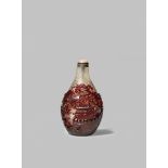 A FINE CHINESE RED-OVERLAY GLASS 'PAVILION' SNUFF BOTTLE 18TH CENTURY The pear-shaped body carved