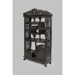 A CHINESE HARDWOOD DISPLAY CABINET LATE QING DYNASTY Carved with bamboo, prunus, chrysanthemum and