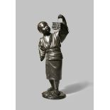 A JAPANESE TOKYO SCHOOL BRONZE OKIMONO OF A BOY MEIJI 1868-1912 The boy depicted standing, lifting a