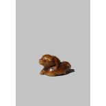 A JAPANESE WOOD NETSUKE MEIJI 1868-1912 Depicting two puppies, one with its eyes shut and the