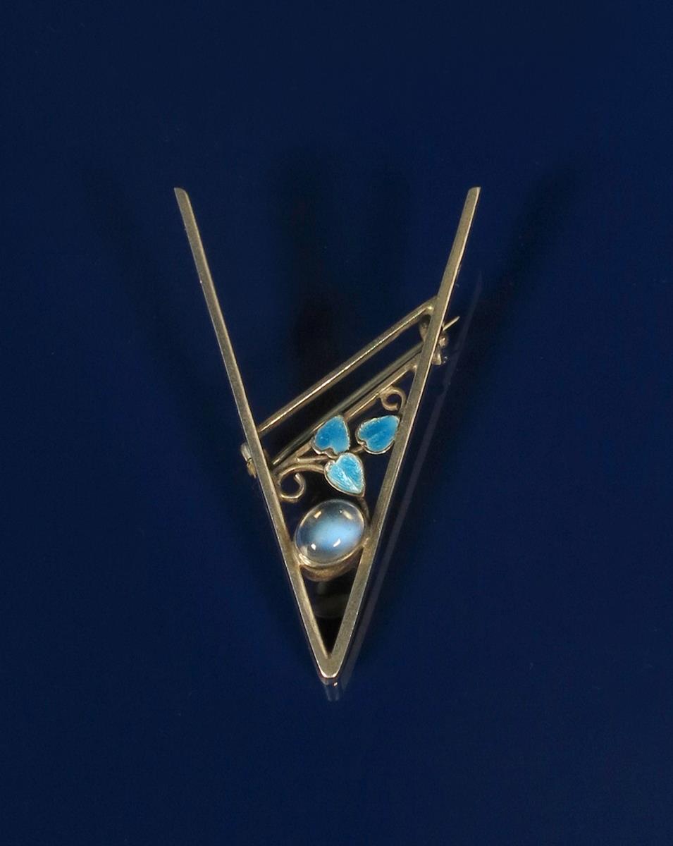 A George Hunt silver brooch, silver V shape frame set with moonstone, with wirework foliate panel