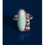 A silver and Amazonite ring, wide, slender amazonite on cast, off-set foliate mount, the shank of