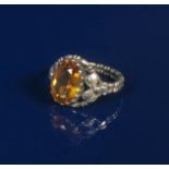 A silver and citrine ring in the manner of Kate Eadie, the shoulder cast and pierced with flowerhead