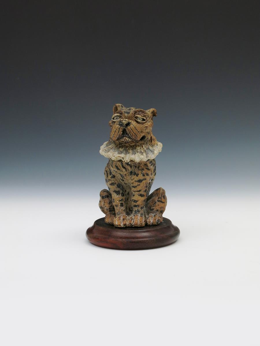 A Martin Brothers stoneware Toby dog jar and cover by Robert Wallace Martin, modelled seated and