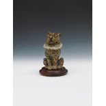 A Martin Brothers stoneware Toby dog jar and cover by Robert Wallace Martin, modelled seated and