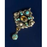 A silver and turquoise pendant, cast in low relief with foliate border, set with abalone shell,