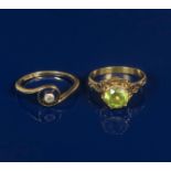 An Art Nouveau Theodore Fahrner gold ring, set with small diamond, and another yellow metal castle