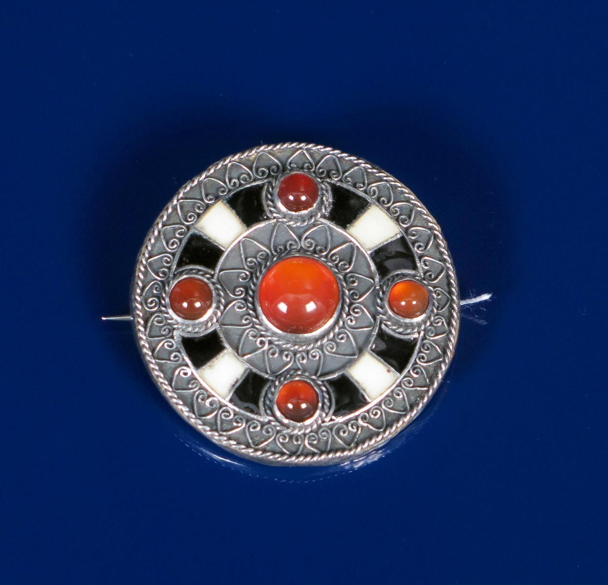 A William Thomas Blackband Medieval Revival silver brooch, circular with cast geometric bands and