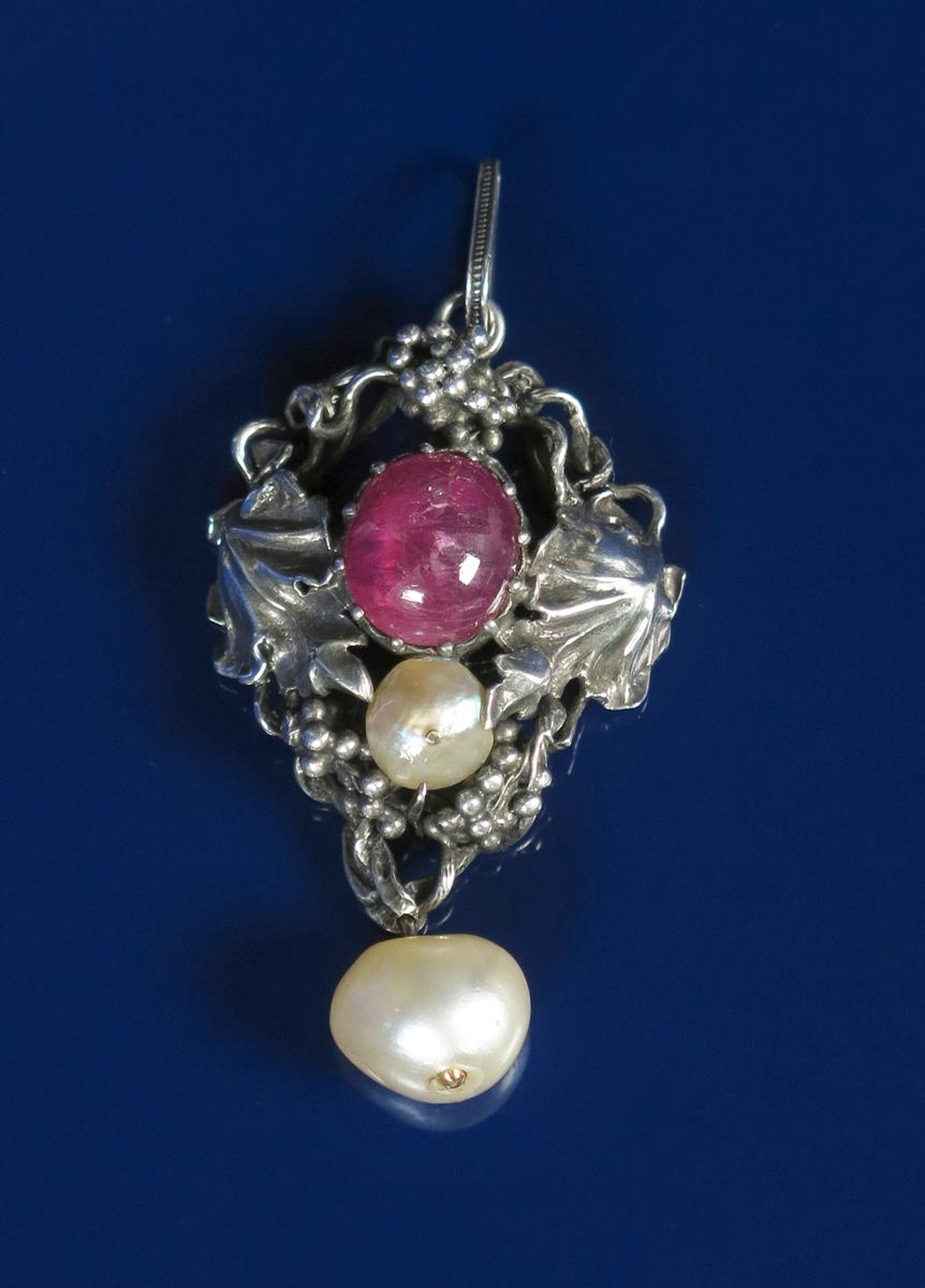 A silver pendant necklace probably by G H Penny, cast and pierced with berried foliage, set with