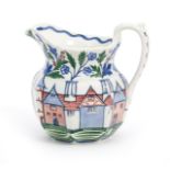 A Wedgwood Pottery jug by Alfred Powell, octagonal form, painted with a frieze of medieval houses,