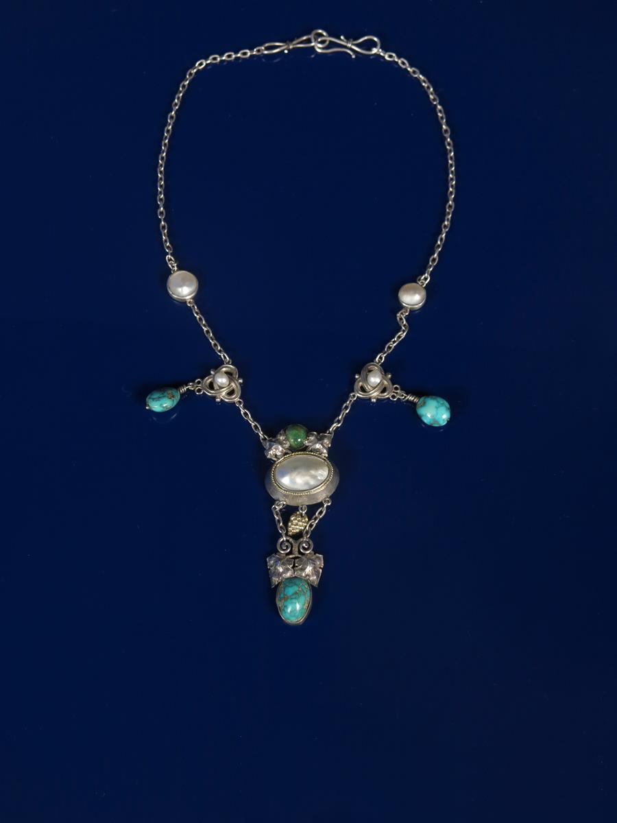 An Artificers Guild silver necklace probably designed by Edward Spencer, central elliptical mother