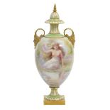 A Doulton Burslem cabinet vase and cover by G White, the urn shaped vase with applied mask