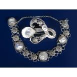A Celtic silver and blister pearl brooch, cast and pierced with entrelac and rope panels, set with