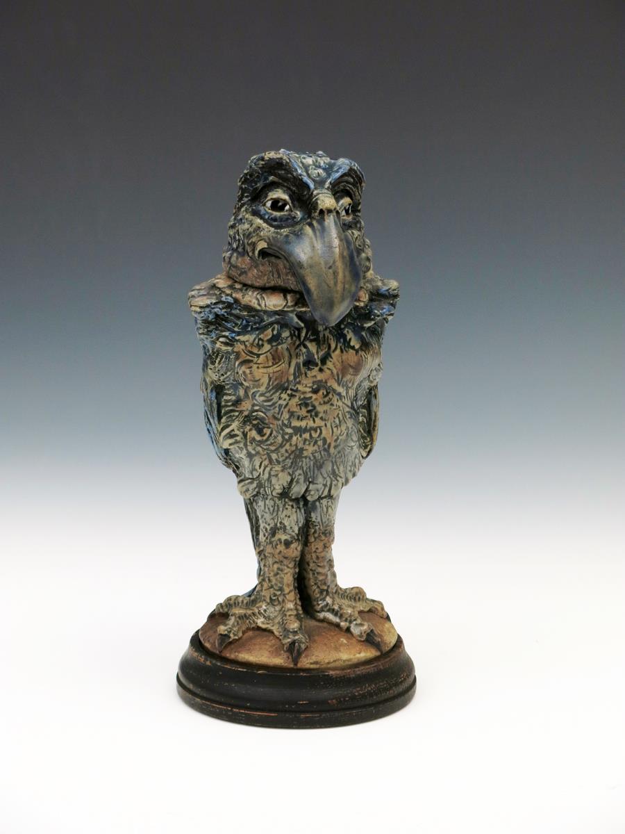 A Martin Brothers stoneware bird jar and cover by Robert Wallace Martin, dated 1911, modelled