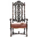 A walnut highback open armchair in early 18th century style, the pierced back carved with scrolls