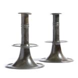 A pair of pewter trumpet base candlesticks, each with a rimmed nozzle above a twin knopped stem