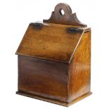 An elm and fruitwood hanging candle box, with an oak hinged lid, 36cm high, 25.7cm wide, 17.5cm