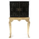 λ A Flemish ebony cabinet, decorated with ripple mouldings, the hinged top revealing a vacant