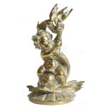 A Victorian brass doorstop, cast with a cherub riding a dolphin, with a registration lozenge, 41cm