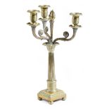 An early 19th century gilt brass candelabrum, with three leaf decorated scroll branches, with drip-