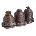 Two 19th century treen lignum vitae beehive string boxes, each with turned and carved decoration,