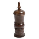 A George III treen lignum vitae coffee grinder, the lid with a stylised acorn finial, above a ring