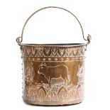 A late 19th century Dutch copper log bin, with a brass swing handle, the riveted body repoussé