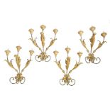 A set of four continental painted wood and metal Baroque style wall lights, with scroll leaf and