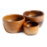 Three treen lignum vitae turned bowls, 12.2cm diameter (max). (3)