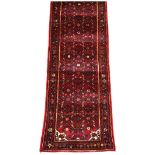 A long Hamadan runner, north west Persia, 1816cm long, 83cm wide. Provenance: Warrens House,