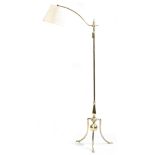 A brass standard lamp in 18th century style, with an adjustable arm, on a baluster stem and tripod