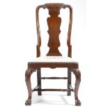 A George II red walnut side chair, the scroll carved top rail above a vase shape solid splat, with a