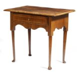A George II walnut lowboy, the quarter veneered top with feather and crossbanding, above a frieze