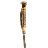 A 19th century antler handled honing steel, carved with a bull's head finial, with glass eyes,